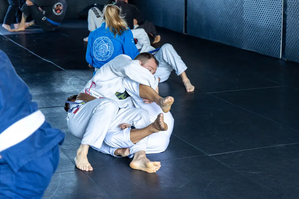 Two teammates working through a ground position