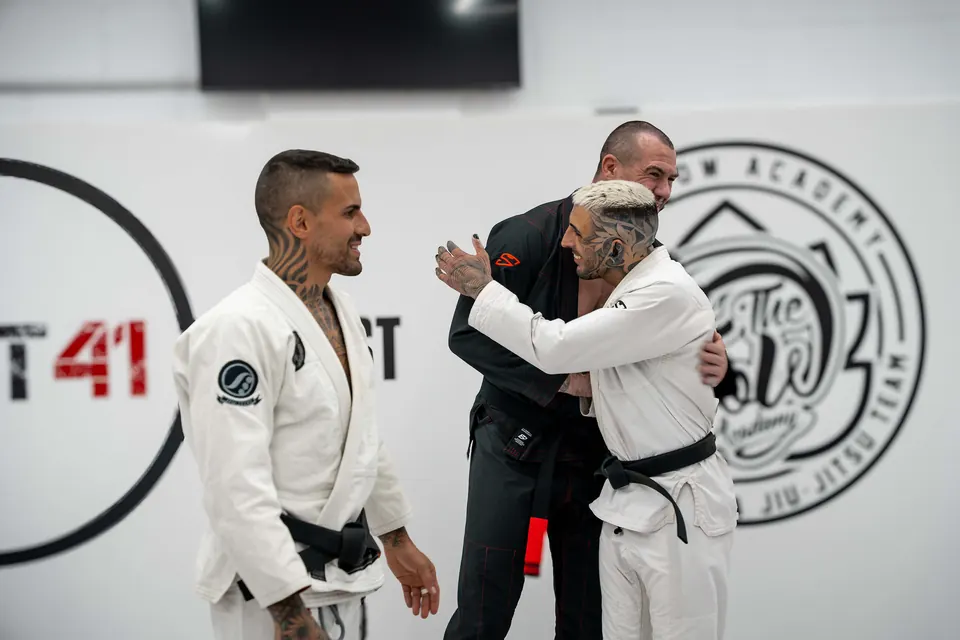 Academy teammates greeting each other after training